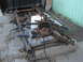1983 Ford F-250 - Disassembled truck chassis with fuel tank, leaf springs, and brake drum visible.
