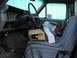 1983 Ford F-250 - The interior of a truck is cluttered with boxes and parts, obscuring details of the vehicle.