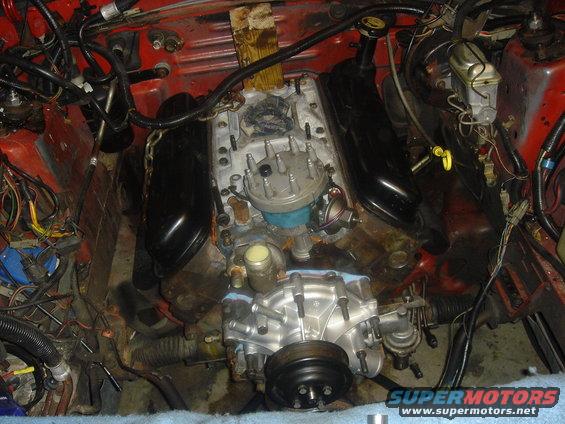Engine bay with V8 engine, likely from a 1986 Ford Mustang