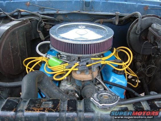 Engine bay showing blue valve covers, yellow spark plug wires, and an aftermarket air filter