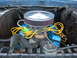1979 Ford Bronco - Close-up of an engine bay with prominent blue valve covers and yellow spark plug wires.