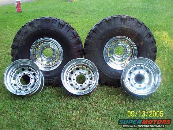 Four chrome wheels and two large tires on grass. Date stamp reads 09/13/2005