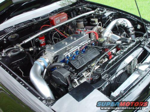 1992 Ford Probe engine bay with aftermarket turbocharger and intake