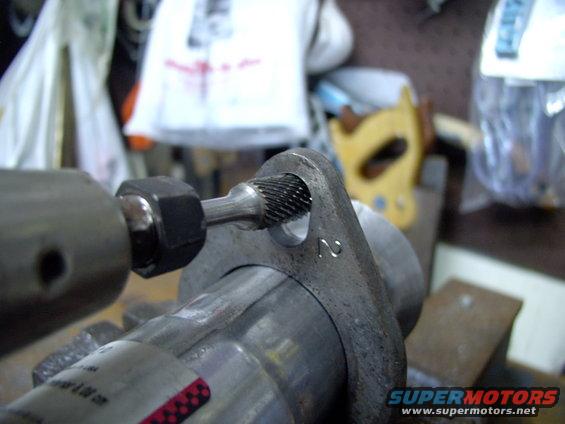 My die grinder made short work of opening them up until they were plenty big enough to accept the Lincoln's manifold studs. A normal power drill would do the same thing, just takes more time.