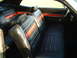 1971 Ford Torino - The interior of a 1971 Ford Torino showcases its distinctive black vinyl seats with red stripe accents.
