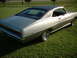 1971 Ford Torino - Rear view of a 1971 Ford Torino GT with a black vinyl roof, parked on a grassy lawn.