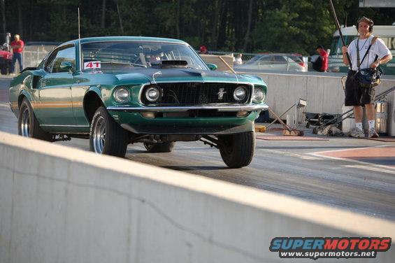 Green 1969 Ford Mustang drag racing, front view