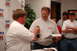 2005 Ford Deluxe - Award ceremony with multiple attendees, one person receiving a trophy.