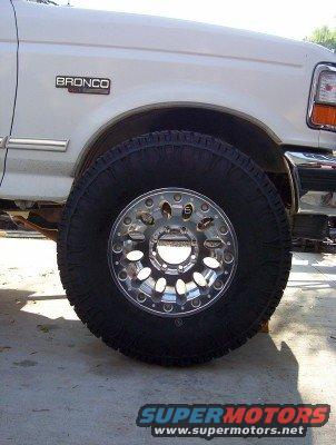 1995 Ford Bronco fender with 'BRONCO' badge and large off-road tire on chrome wheel
