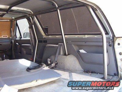 1995 Ford Bronco interior with roll cage and removed rear seat
