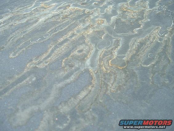 close-up of a textured surface with streaks of rust and dirt
