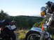 1981 Honda CB750 - Two motorcycles are parked on a grassy overlook with a view of rolling hills and a clear blue sky.