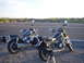 1981 Honda CB750 - Two motorcycles are parked side-by-side on a paved surface, with a dry, vegetated landscape in the background.
