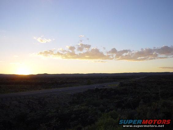 Sunset over a rural landscape with a road
