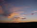 1981 Honda CB750 - The sky displays a dramatic mix of pink and orange clouds during a sunset, with a dark horizon line.