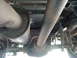 1995 Ford C-350 (Centurion Conversions) - Undercarriage view shows the exhaust system and driveshaft of a truck, with visible suspension components.