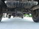 1995 Ford C-350 (Centurion Conversions) - Underside view showing the rear differential and suspension components of a vehicle.