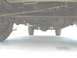 1995 Ford C-350 (Centurion Conversions) - The underside of a truck reveals its drivetrain components, including the rear differential and suspension system.