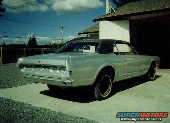1968 Mercury Cougar coupe with black vinyl top, silver paint, and missing rear bumper