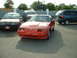 1985 Nissan 300ZX - A red sports car with pop-up headlights is parked in a lot, with other vehicles nearby.