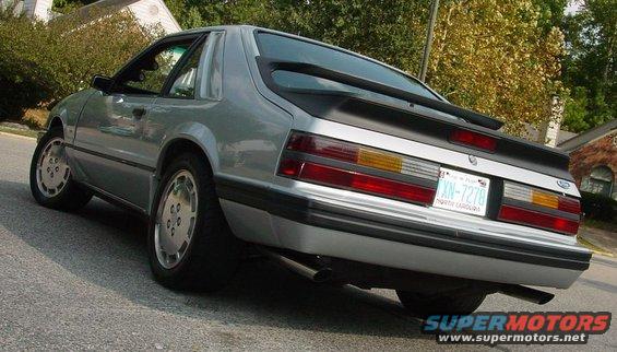 Silver 1986 Ford Mustang rear 3/4 view, showing a spoiler and North Carolina license plate
