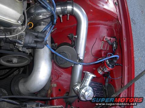 Engine bay showing intake piping, blow-off valve, distributor, and ignition coil