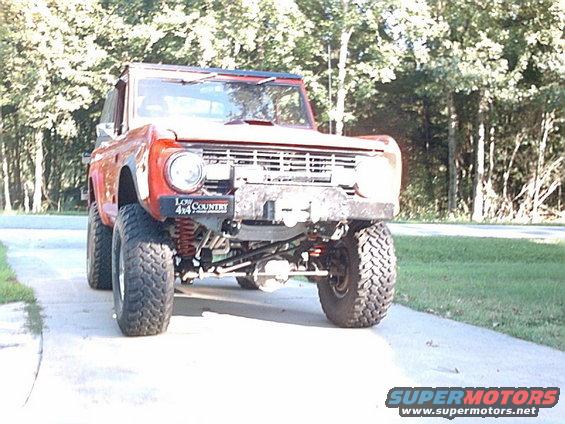 Lifted red SUV with off-road tires and a winch on the front bumper. It has a 'Low Country 4x4' sticker on the fender