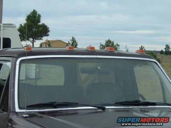 Truck cab roof with orange clearance lights. Part of an RV is visible on the left