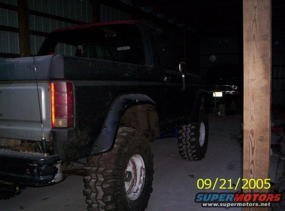 Rear view of black Ford Bronco with lifted suspension and large tires