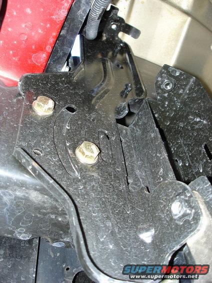 Close-up of a metal bracket with bolts, part of a bumper swap
