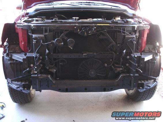 2005 Nissan Titan front end with bumper removed, showing radiator and fan