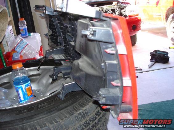 Vehicle bumper assembly and tire with bottles of liquid nearby