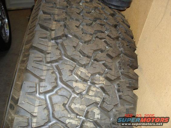 Close-up of a tire tread with a date stamp of SEP 23, 2005