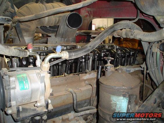 Close-up of diesel engine parts including air intake, fuel injectors, and a filter canister