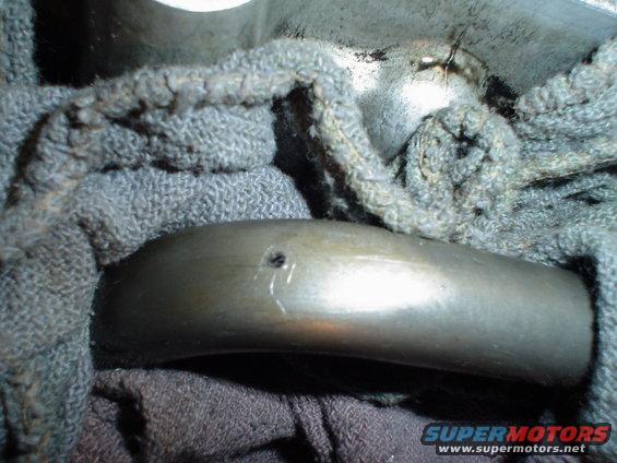 Engine bearing with a hole, wrapped in gray cloth