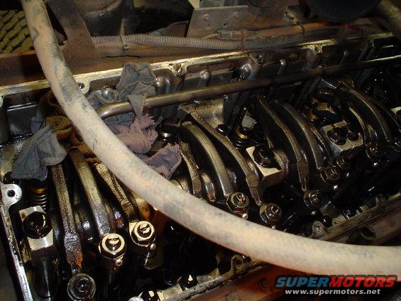 Close-up of an engine's valve train with rocker arms and springs visible