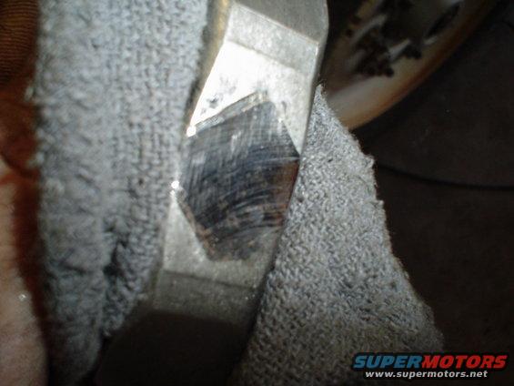 Close-up of a metal component covered partially by gray fabric