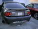 2004 Ford Mustang - Rear view of a 2004 Ford Mustang GT, with another vehicle partially visible to the right.