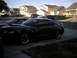 2004 Ford Mustang - Black 2004 Ford Mustang coupe parked in a suburban driveway.