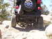 1989 Ford Bronco - A Jeep Wrangler navigates a challenging rocky terrain, its off-road capabilities.
