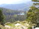 1989 Ford Bronco - A mountain landscape a small lake amongst dense pine trees.