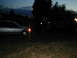 1995 Ford Escort - Two vehicles are parked outdoors at dusk, one a silver sedan and the other a dark SUV.