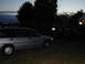 1995 Ford Escort - Silver 1995 Ford Escort wagon and a dark SUV are parked outside as twilight fades.