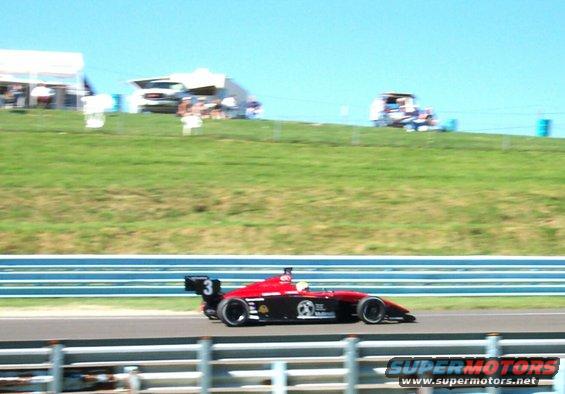 Open-wheel race car with number 3 on the rear wing, on a track