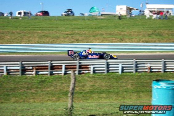 Open-wheel race car with number 51 and Red Bull livery on a race track