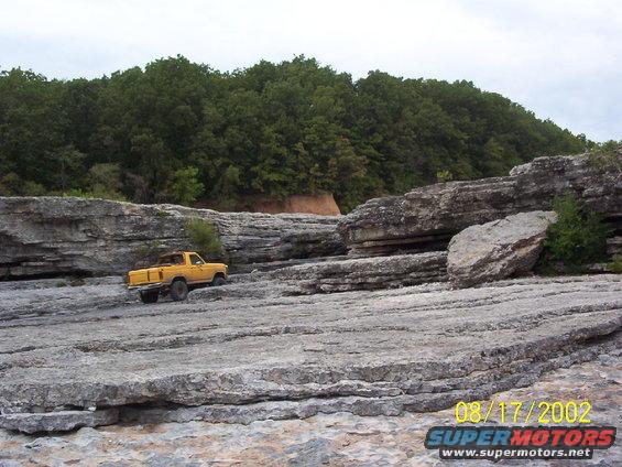 Yellow pickup truck on rocky terrain