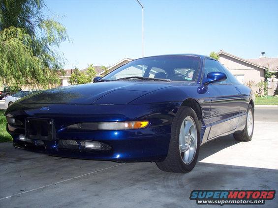 Blue 1995 Ford Probe parked in driveway, front 3/4 view