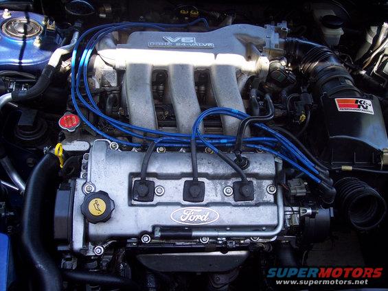 Engine bay with V6 DOHC 24-VALVE intake manifold and Ford branding