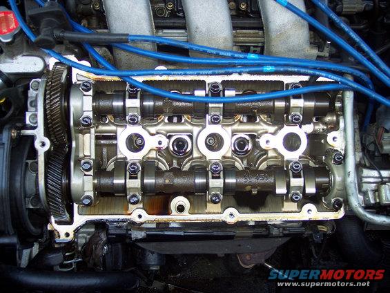 Engine with valve cover removed, showing camshafts and spark plug wires