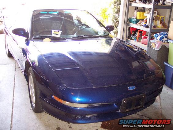Front view of a blue 1995 Ford Probe parked in a garage